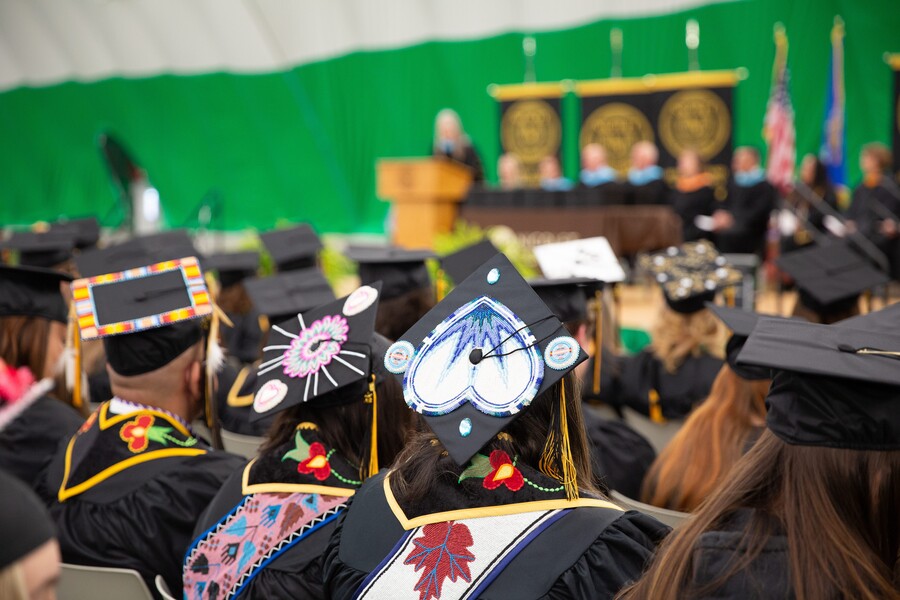 back of beaded tribal graduation caps at the 2024 Nicolet commencement ceremony