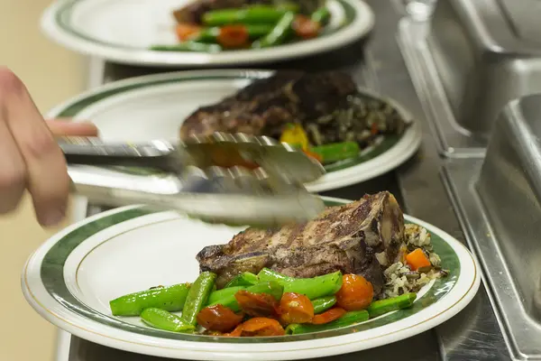 chef hands plating food