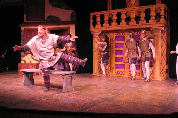 The Nicolet Players performing A Funny Thing Happened. Actors in medieval costumes, one actor gesturing dramatically.
