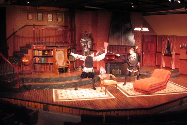 The Nicolet Players performing I Hate Hamlet. Two actors in a cozy living room set.