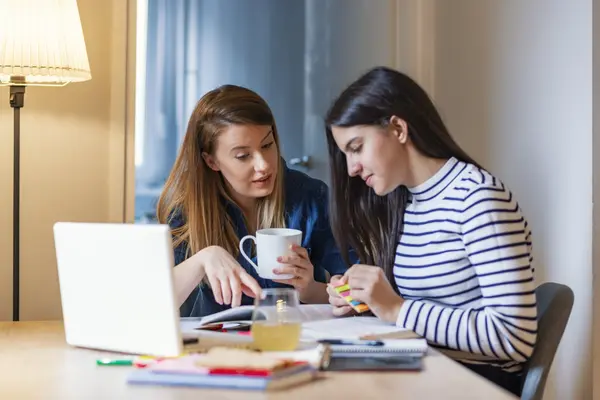 mom and daughter at kitchen table discussing education