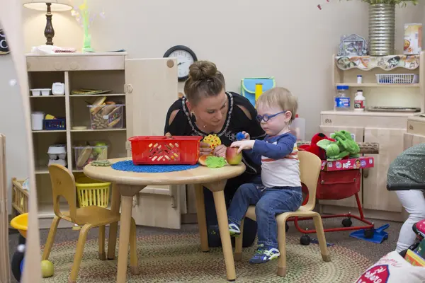 student teaching young boy at daycare