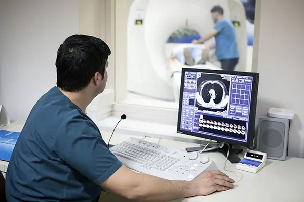 radiography student reviewing an xray on a computer screen