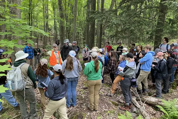 instructor in the woods with students