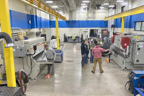 manufacturing lab with students and instructors working on projects