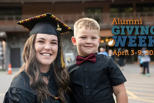 Alumni Shelby Daniels with son at graduation