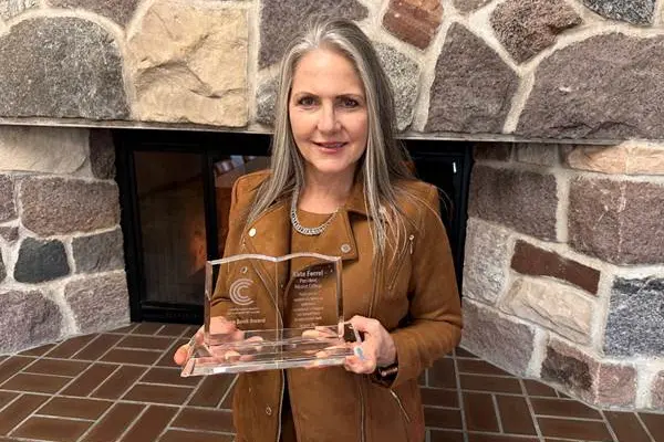 Nicolet College President Kate Ferrel accepts the Open Book Award from CBExchange.