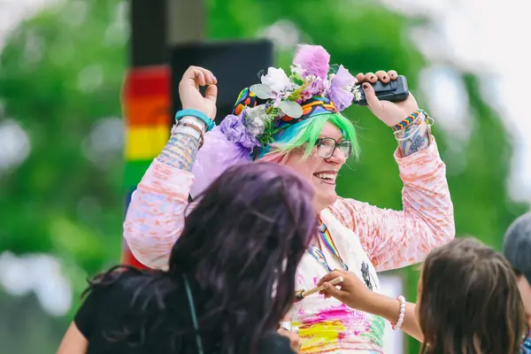 Joyous people celebrating the LGBTQ+ community at the 2024 Northwoods Pride Festival.
