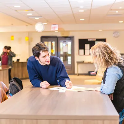 Students talking at a table in Student Services area of Lakeside Center.