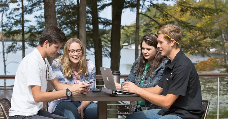 students studying at table outside