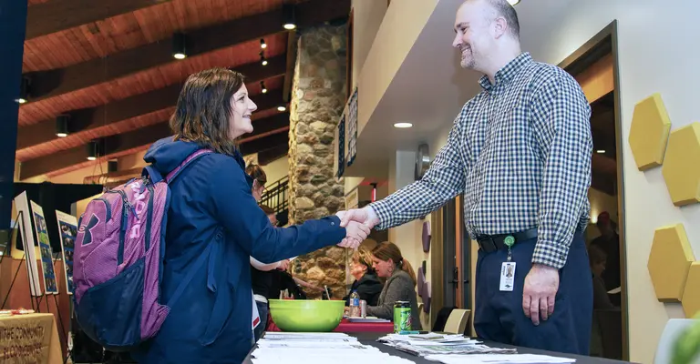 student meeting employer at job fair
