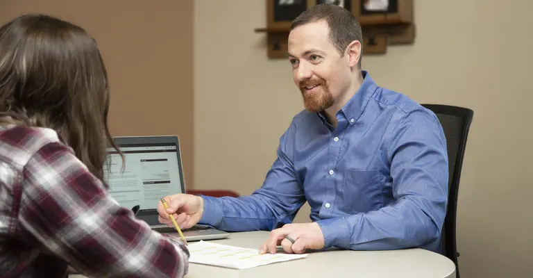 Financial Aid Manager explaining process with student