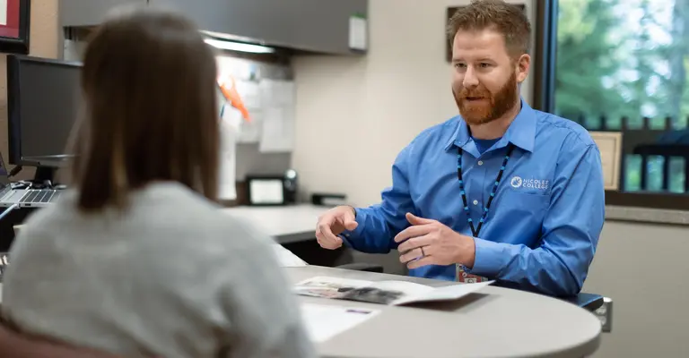 admissions rep meeting with a female student in office