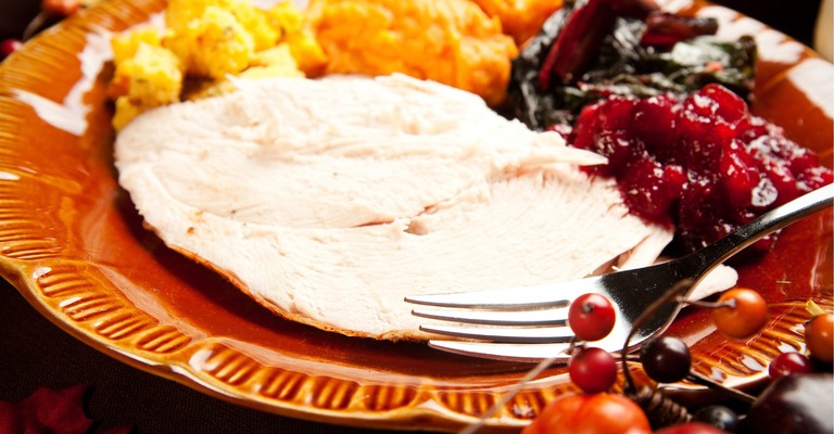 turkey, squash and cranberry on a plate with a fork