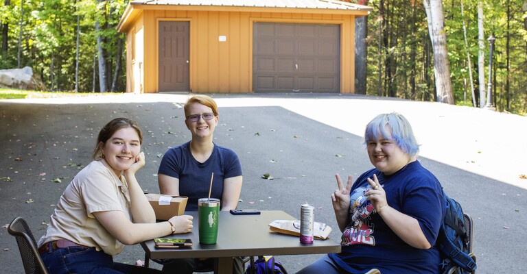 three female students eating lunch and having fun