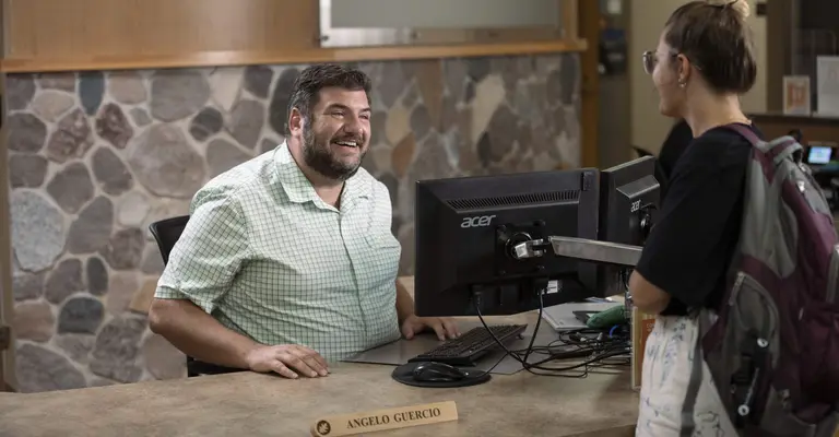 student talking with welcome center service