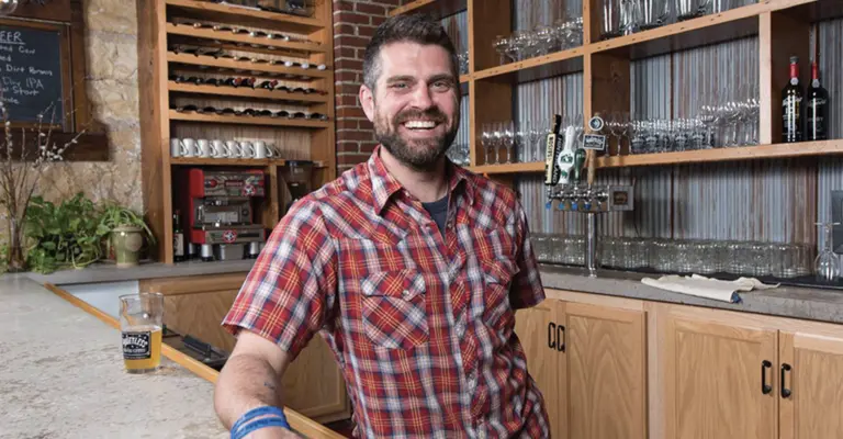 Luke Zahm behind a counter in a restuarant