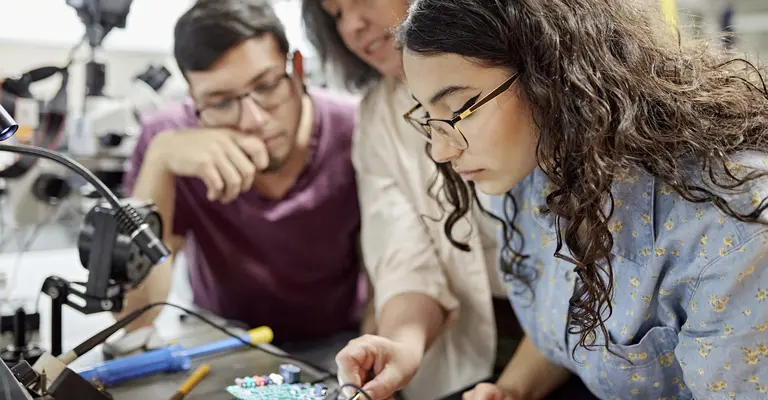 engineering students working on a project with instructor