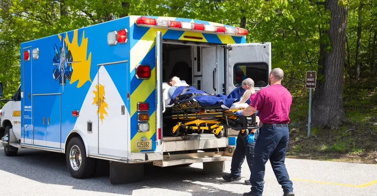 Emergency Response students removing a patient from the ambulance on a stretcher