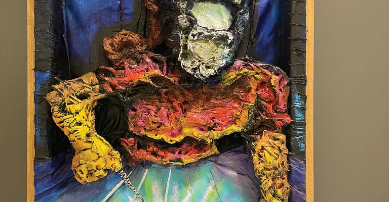 Colorful abstract sculpture of a welder with textured figure and bright background.