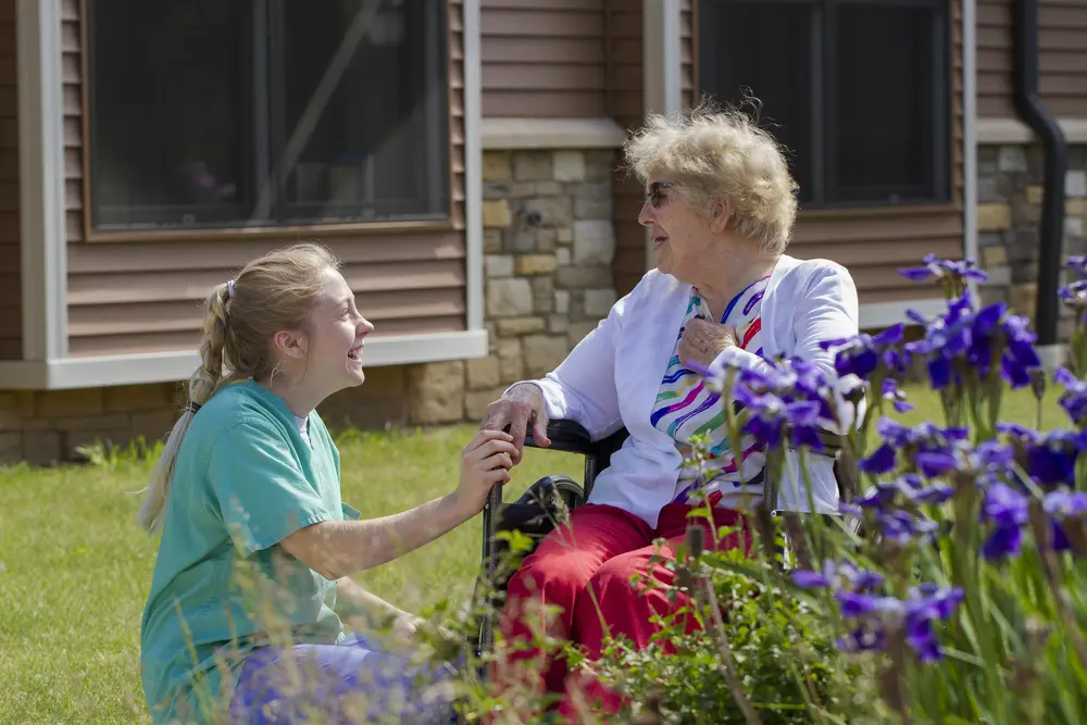 CNA student with patient at healthcare facility