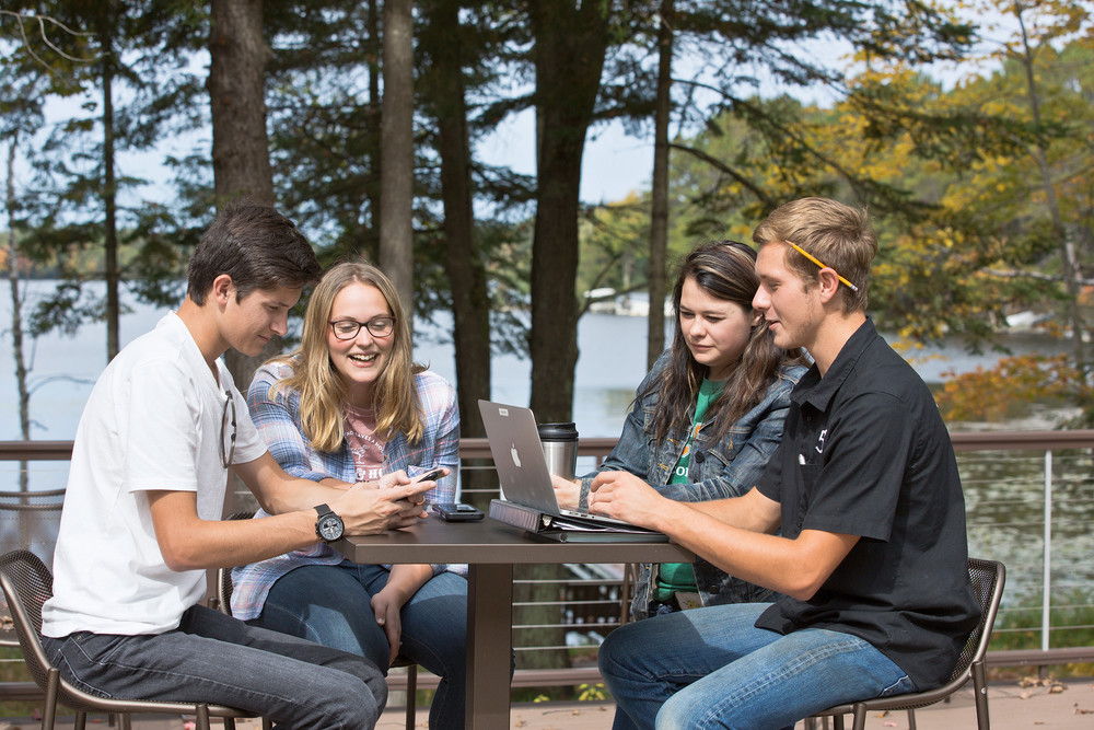 students studying at table outside