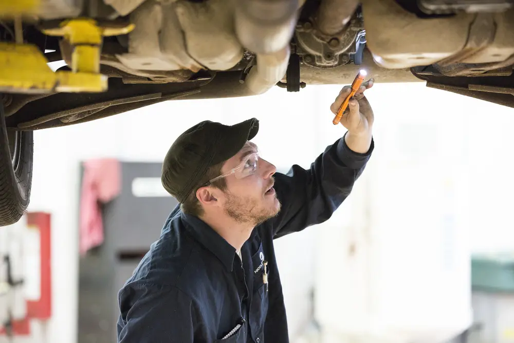 auto student checking tire