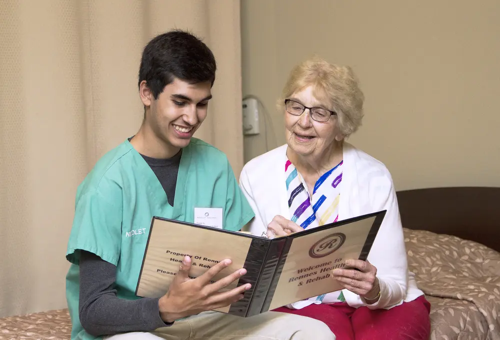 Nursing assistant with patient at rehab facility