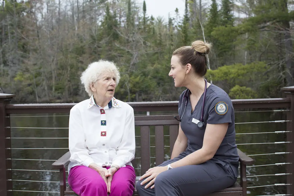 nursing student with patient outdoors