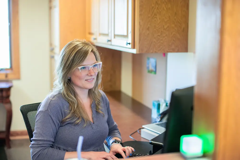 Woman in office using a computer.