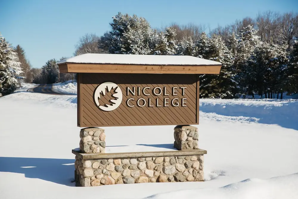 Nicolet College entrance sign in winter.