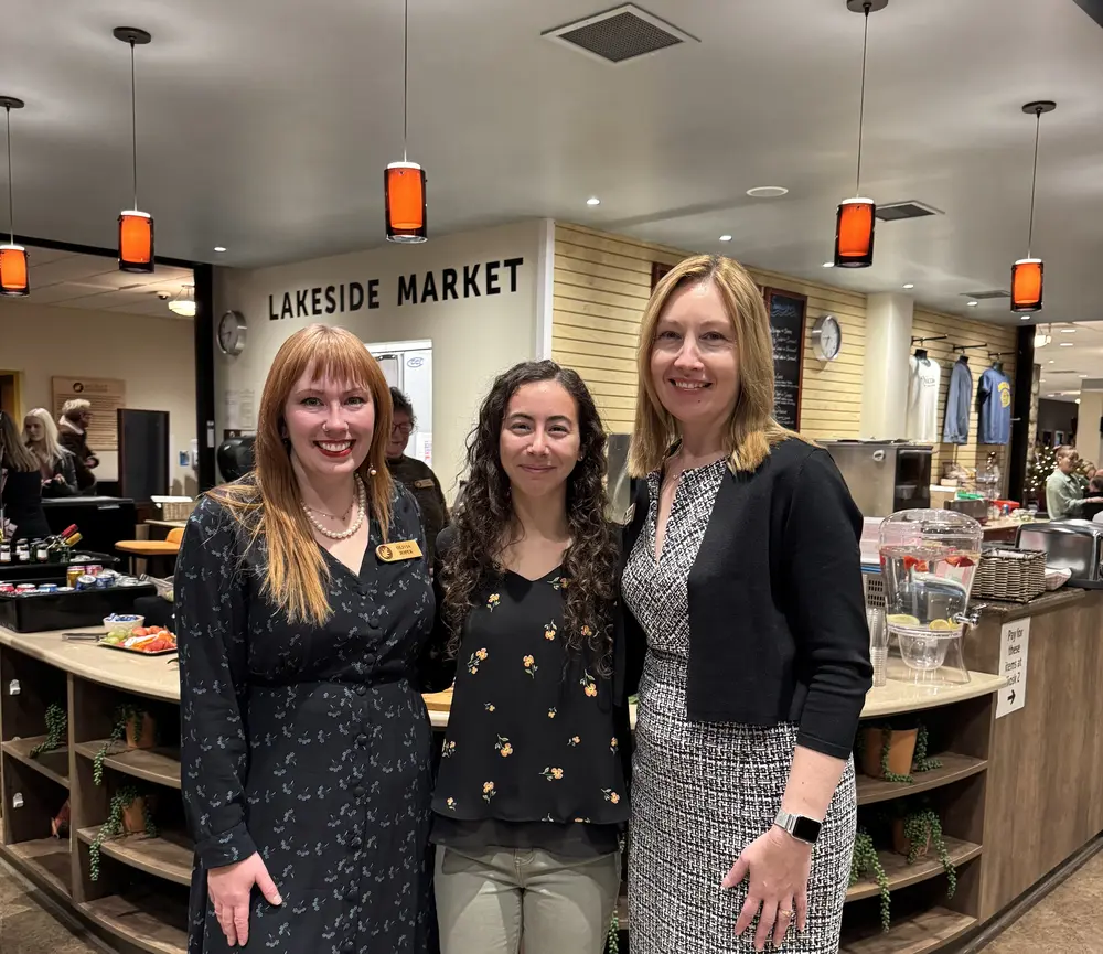 Three women smiling inside Lakeside Market. From left to right: Olivia Jopek, Brynlei Kuhn, and Heather Schallock. 