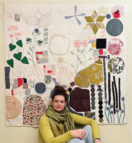 artist with quilt
