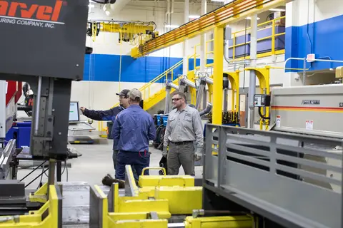 manufacturing lab with instructor demonstrating machine