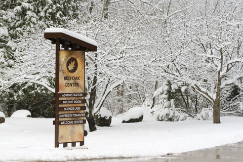 Winter photo of red oak sign in snow