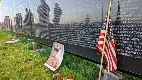 photo of wall that heals with picture of male veteran and flag