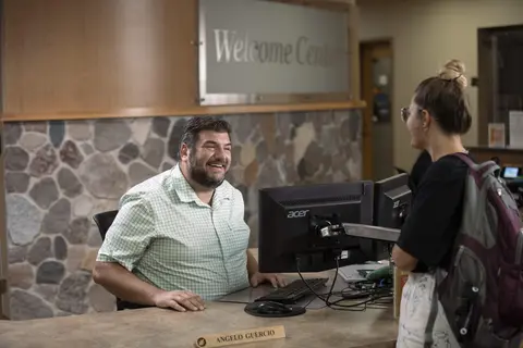 student talking with welcome center service