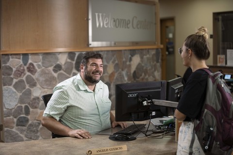 student talking with welcome center service