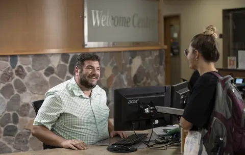 A student getting the help they need at the Nicolet College Welcome Center.