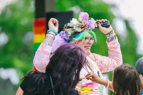 Joyous people celebrating the LGBTQ+ community at the 2024 Northwoods Pride Festival.