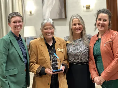 Four smiling women. Layla Merrifield, Dianne Lazear, Kate Ferrel and Abbey Dall Lukowski at the District Board Association banquet.