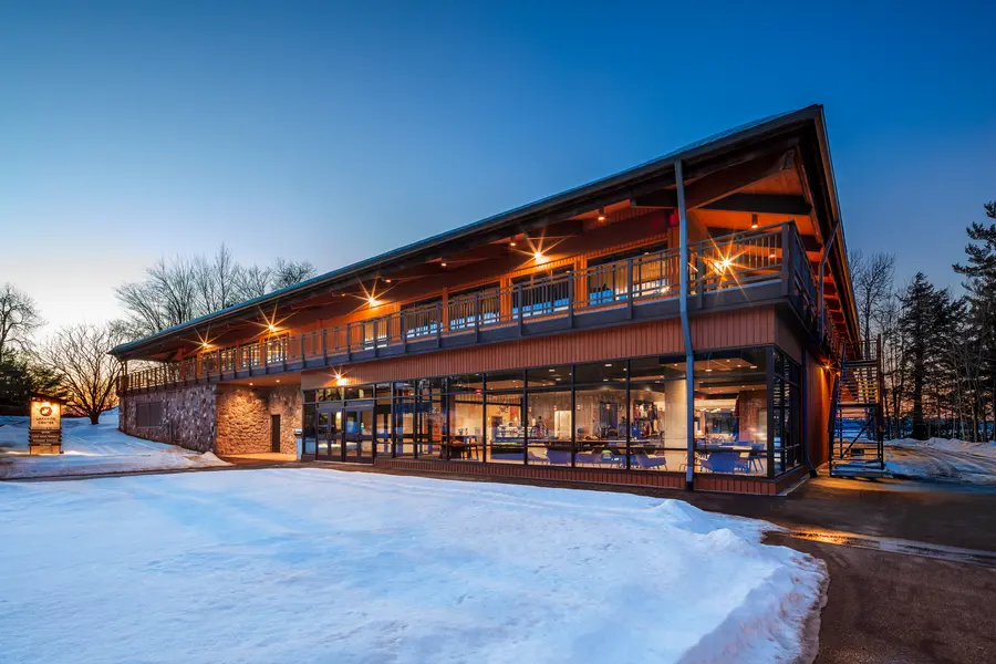Lakeside Center: modern building with large windows, snow-covered ground, early evening light.