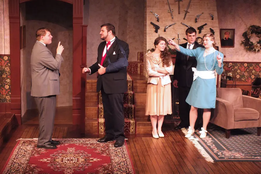 Nicolet Live play scene of Games Afoot with five actors in vintage attire, discussing intensely.