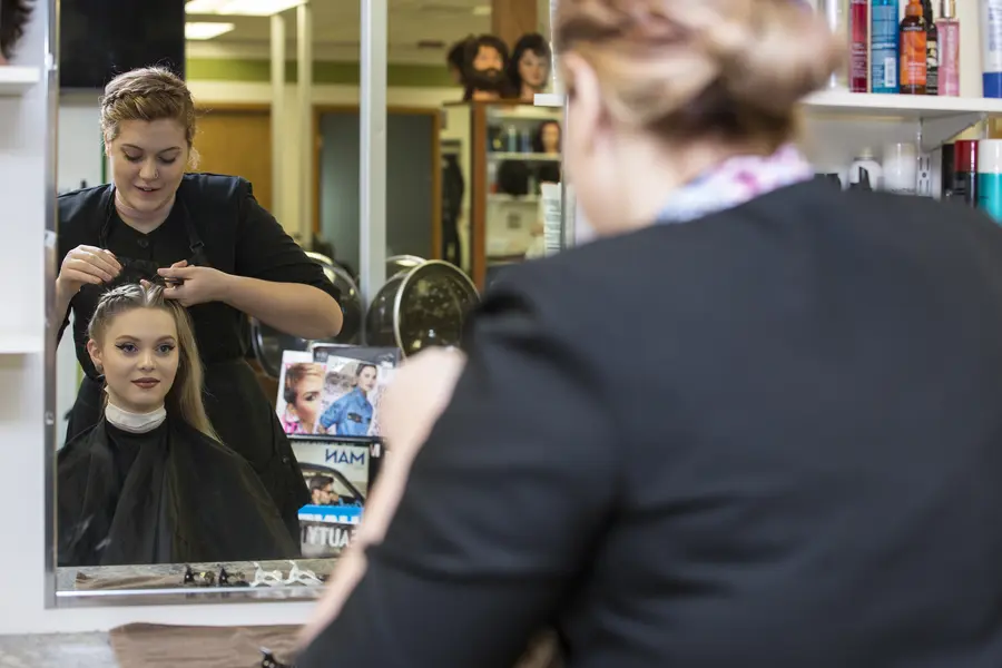 cosmetology student styling hair