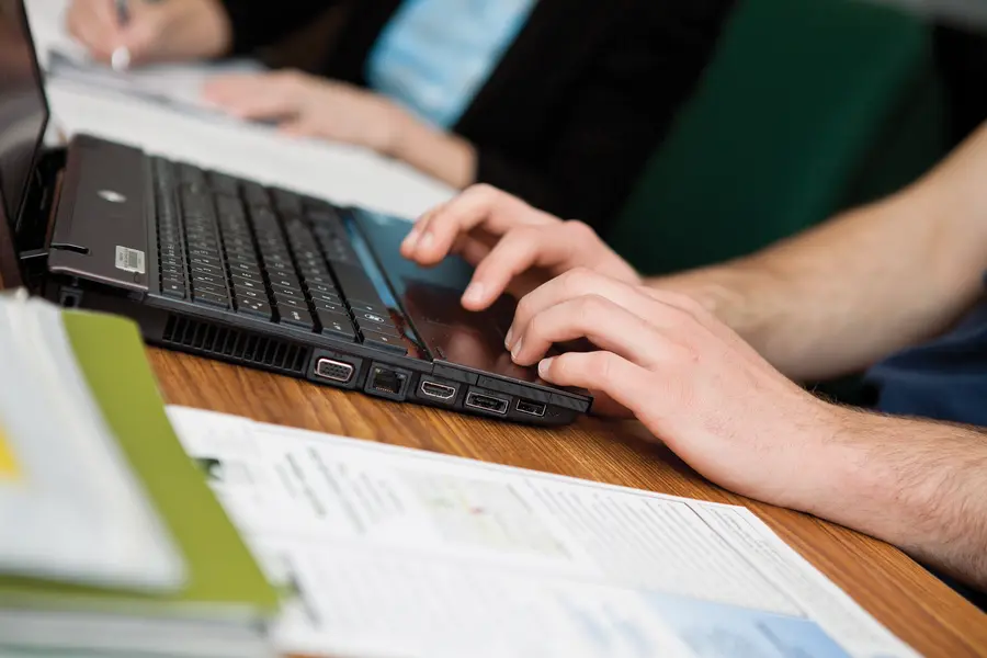 hands on laptop computer keyboard