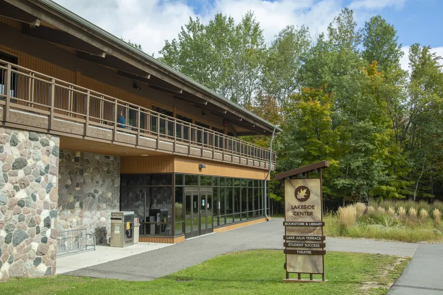Front of the Lakeside Center, surrounded by trees under a blue sky.