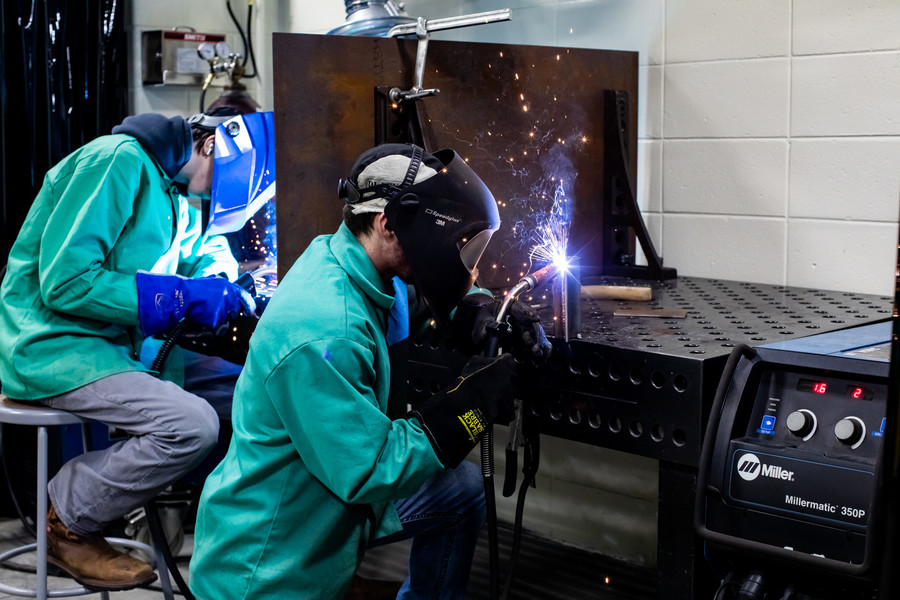 students welding in lab