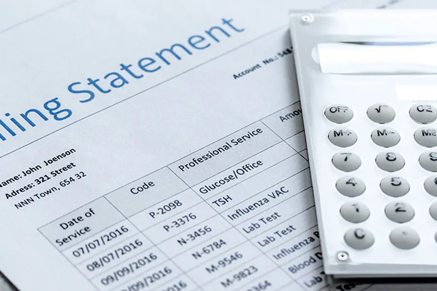 Billing statement with a calculator on top.